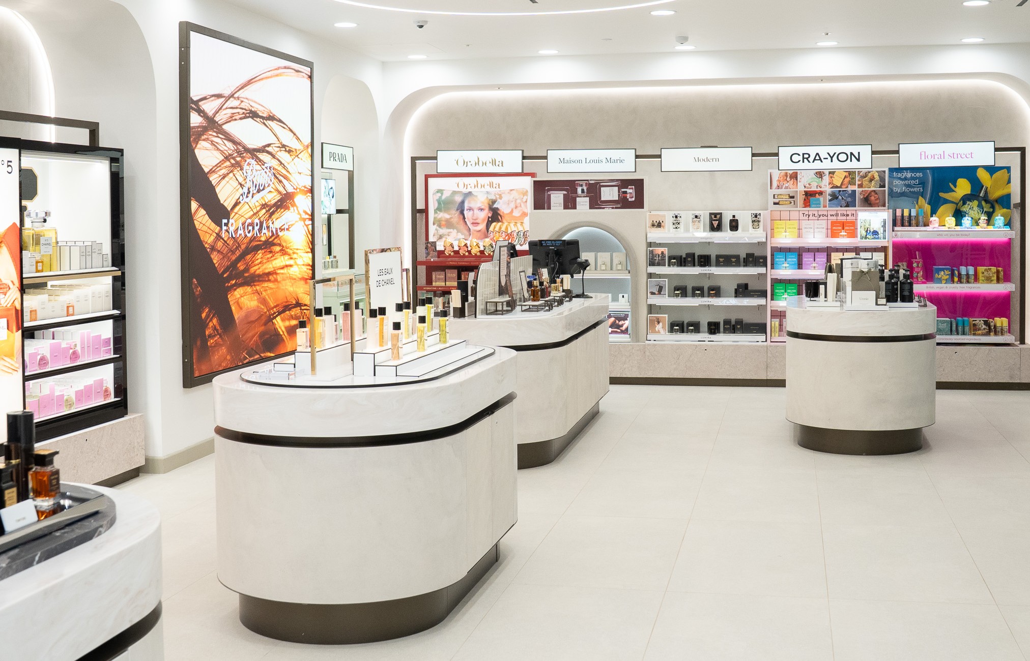 fragrance and cosmetics section of a modern, well-lit retail store, likely a department store or a specialized beauty boutique.