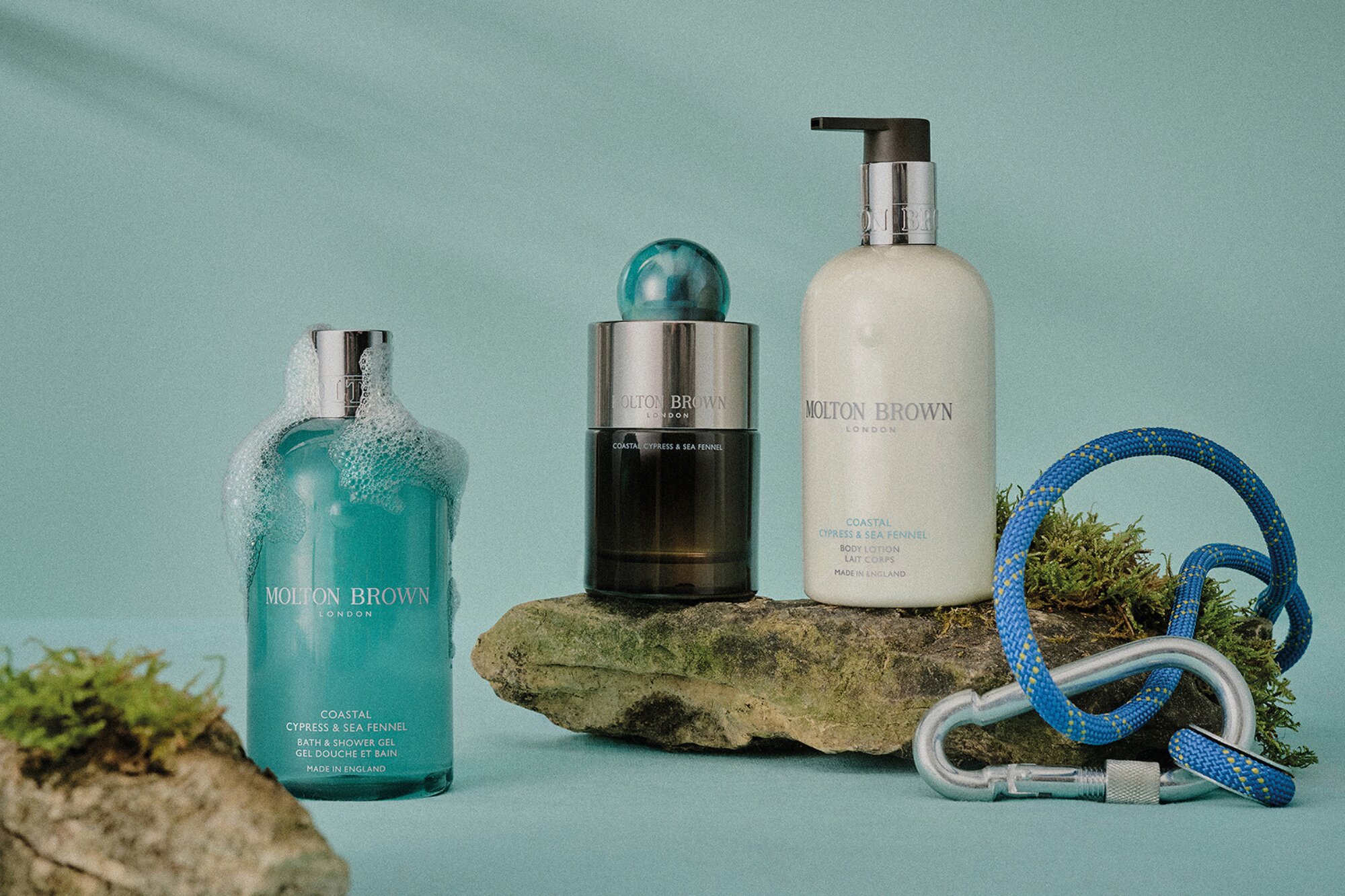 A selection of toiletries from Molton Brown on a teal background