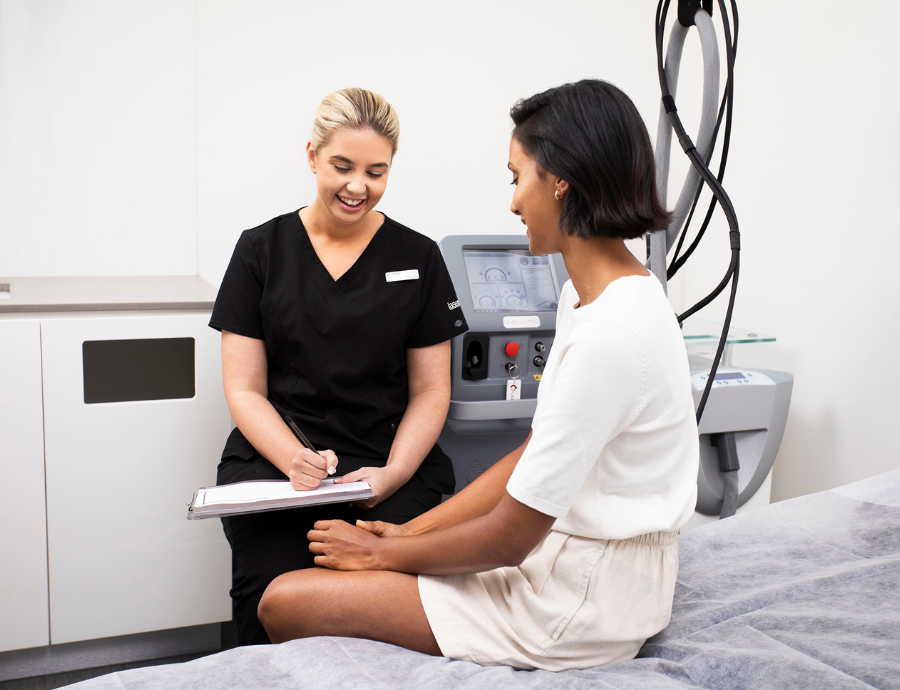 A therapist talking to a customer at a laser clinic.