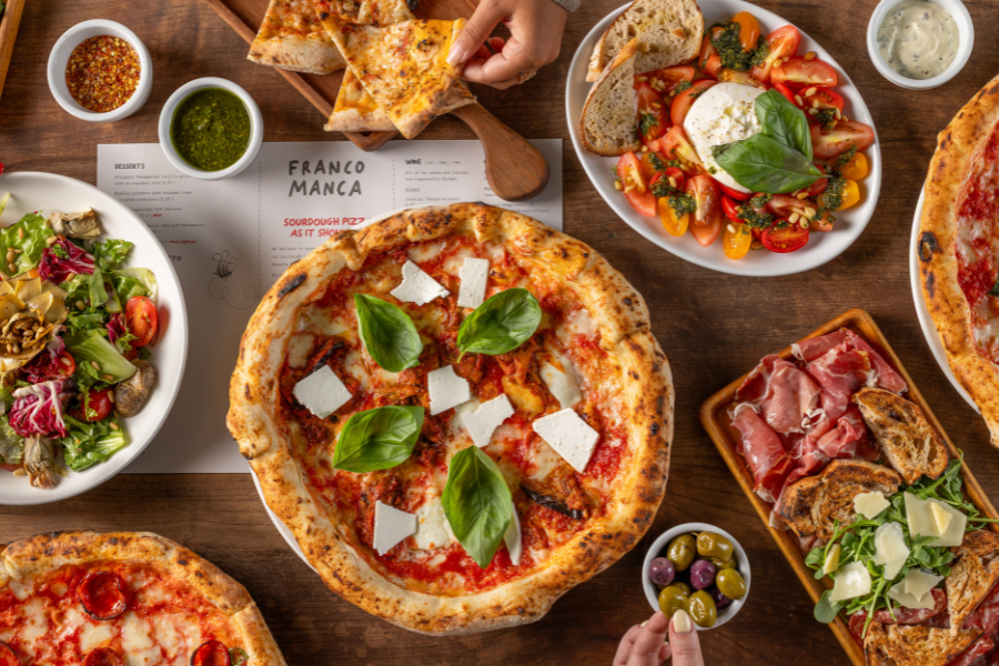 A platter of different pizzas with various toppings