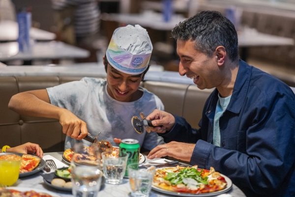 A dad and son eating at Pizza Express.