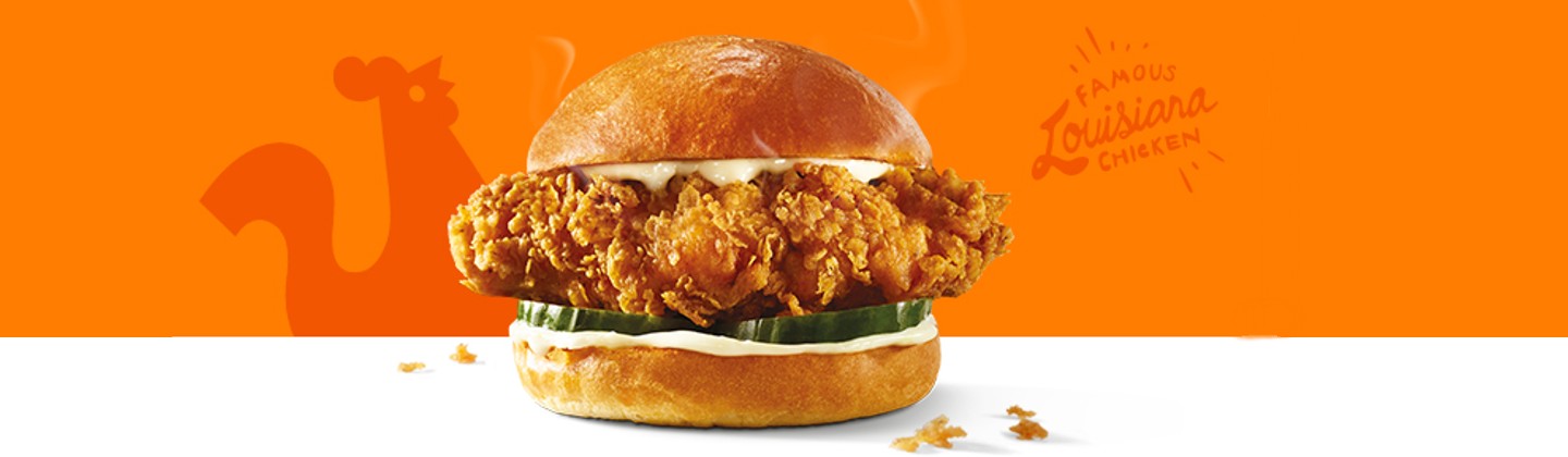 This image is a vibrant, high-quality promotional banner featuring a chicken sandwich.