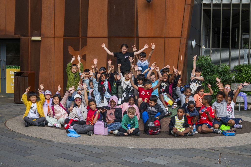 Group of children smiling outside the cinema