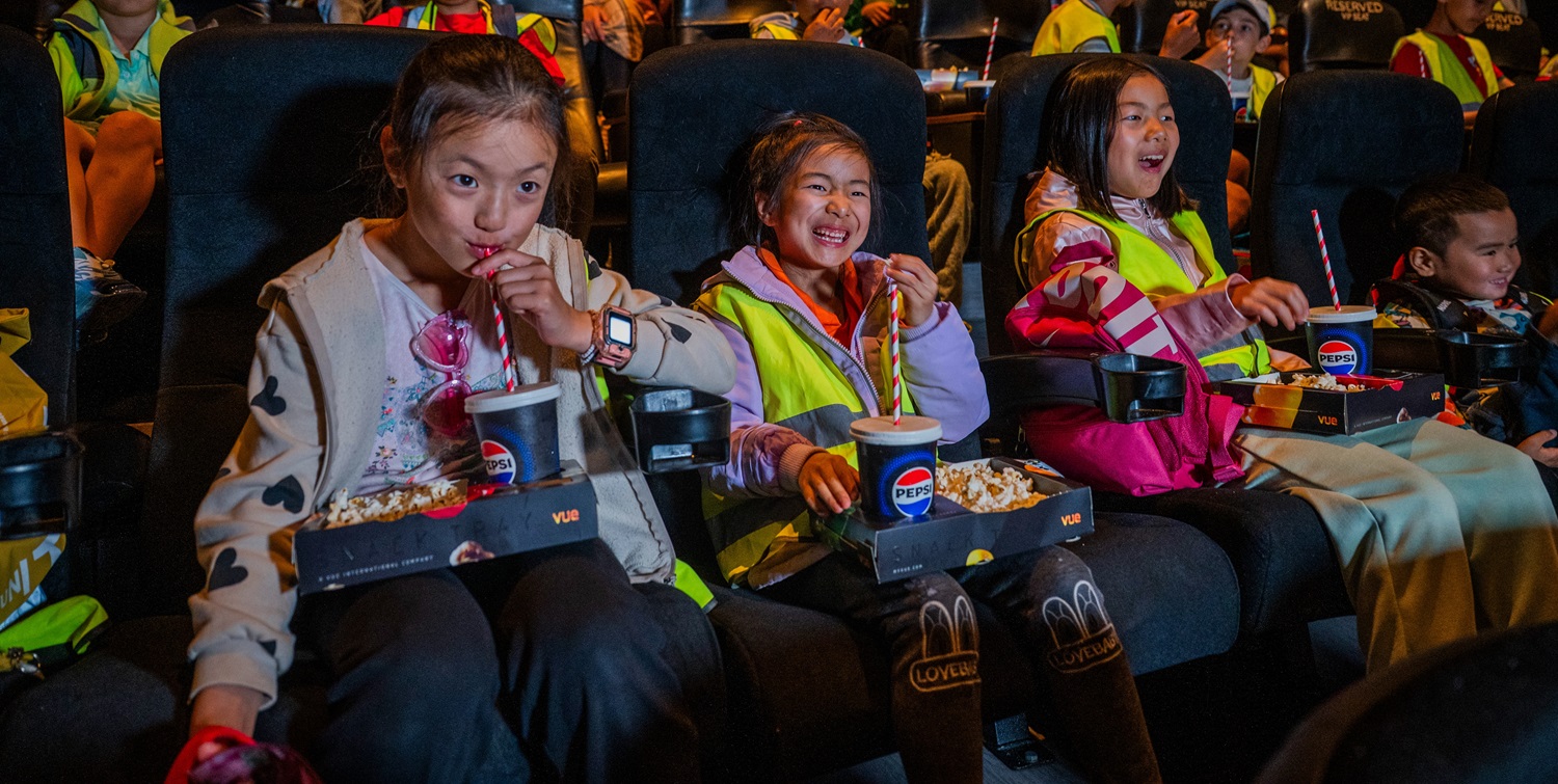 Group of children enoying a film at the cinema