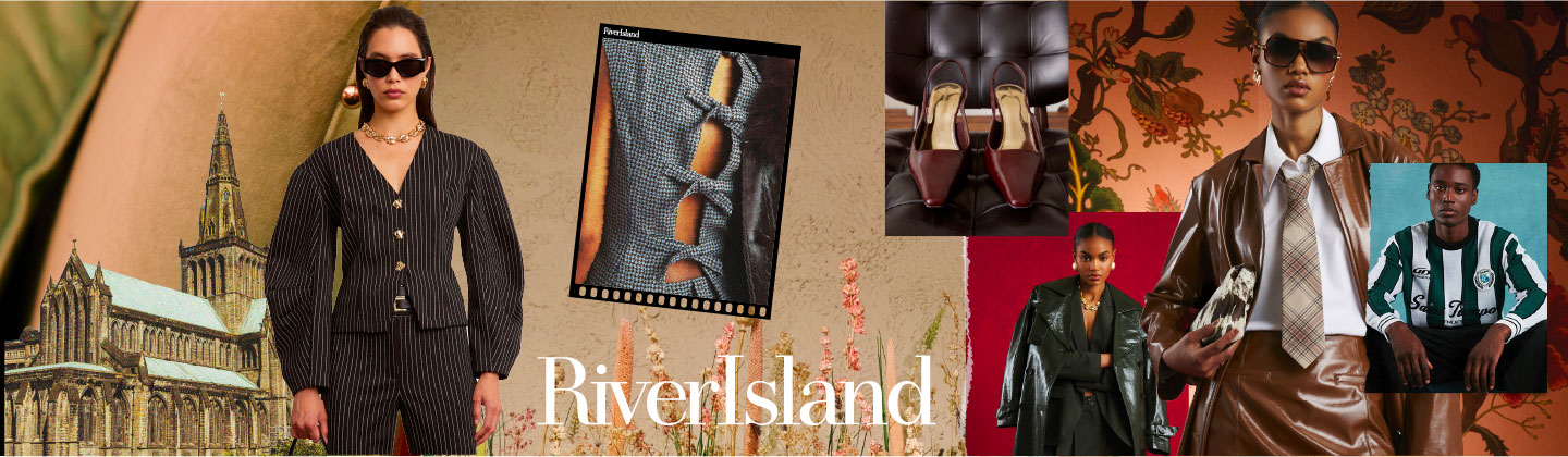 This image is a fashion editorial or advertisement with a striking, stylized aesthetic. The main focus is a woman wearing an outfit that seems to blend classic and contemporary styles: She's wearing a glossy, brown faux-leather jacket over a crisp, white collared shirt. A plaid tie in muted beige, red, and brown tones is worn with the shirt. She's also wearing a matching brown faux-leather mini-skirt. Her accessories include large, dark sunglasses and what appears to be a small, patterned clutch or pouch held in her right hand. The backdrop is a rich, warm, and somewhat dramatic floral or tapestry-like pattern in shades of rust, orange, and deep green.