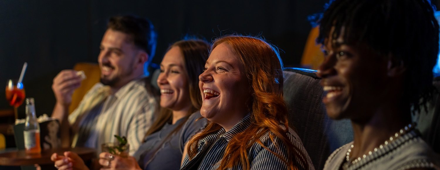 A group of friends watch a film together.