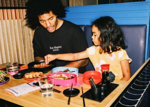 Dad and daughter enjoying a meal at YO Sushi 
