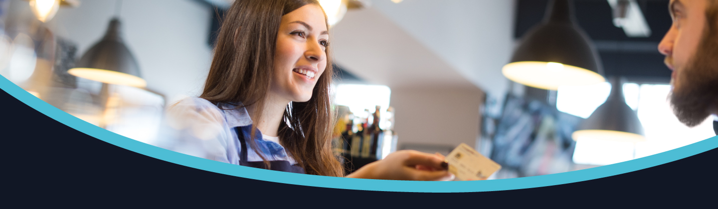 A person serves in a coffee shop.