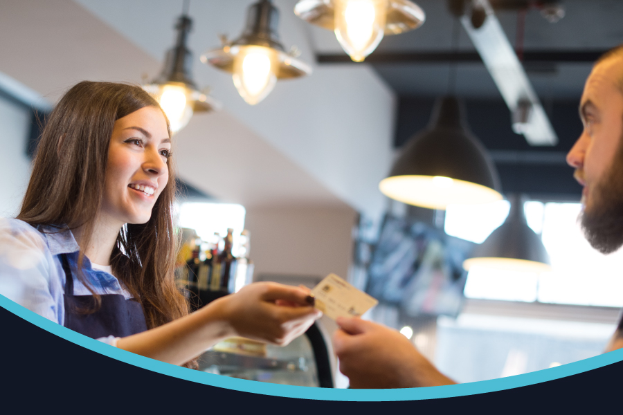 A person serves in a coffee shop.