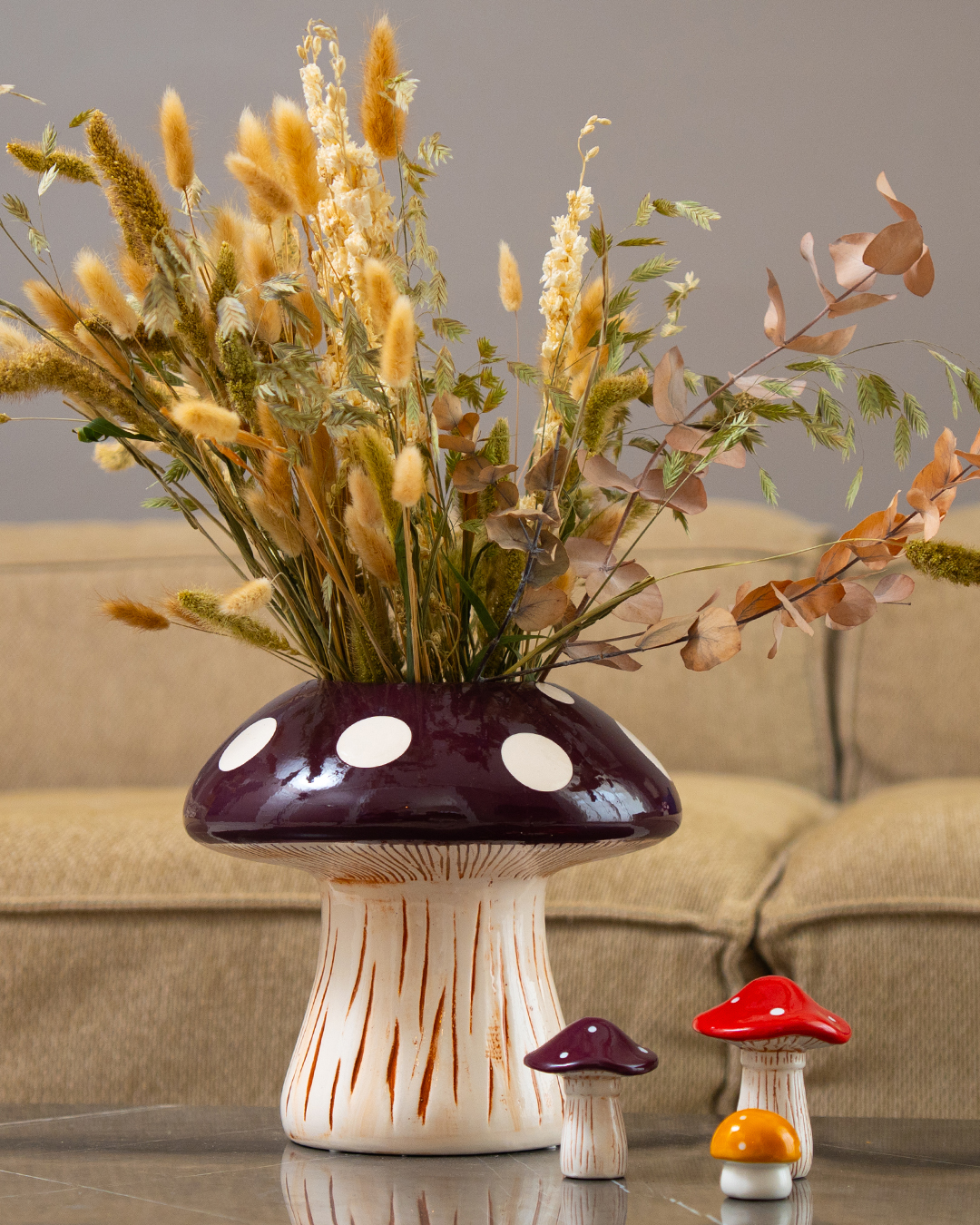 A mushroom shaped vase with foliage on the top.