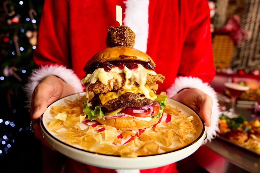 A massive burger on a plate.