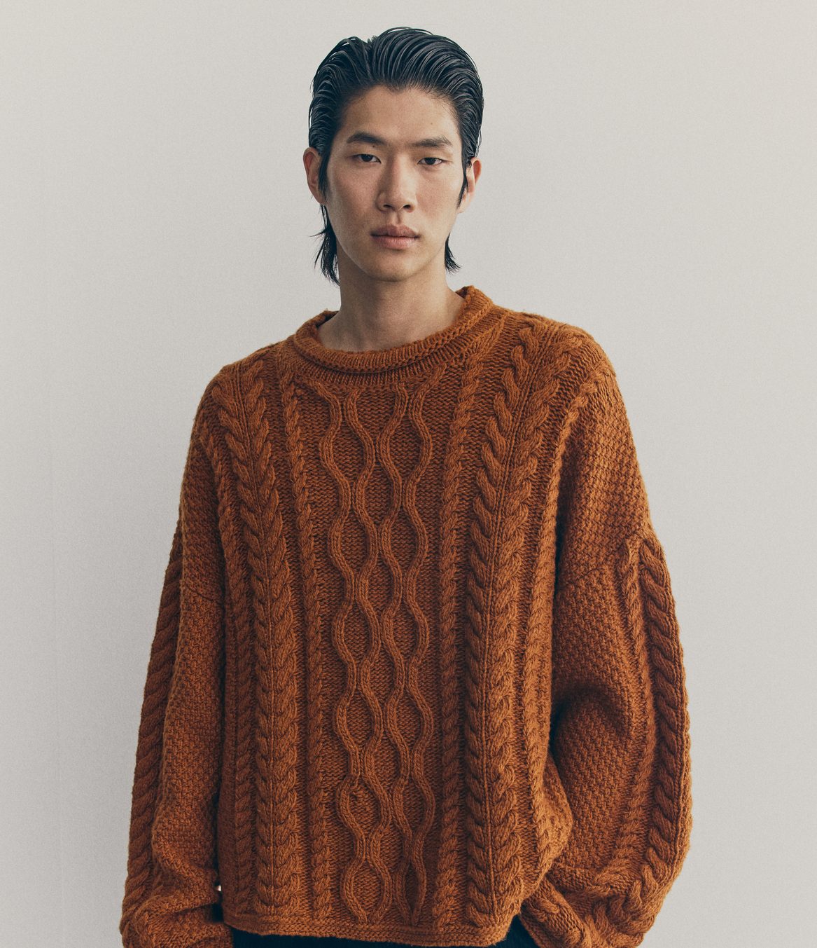 A model wears a burnt orange jumper