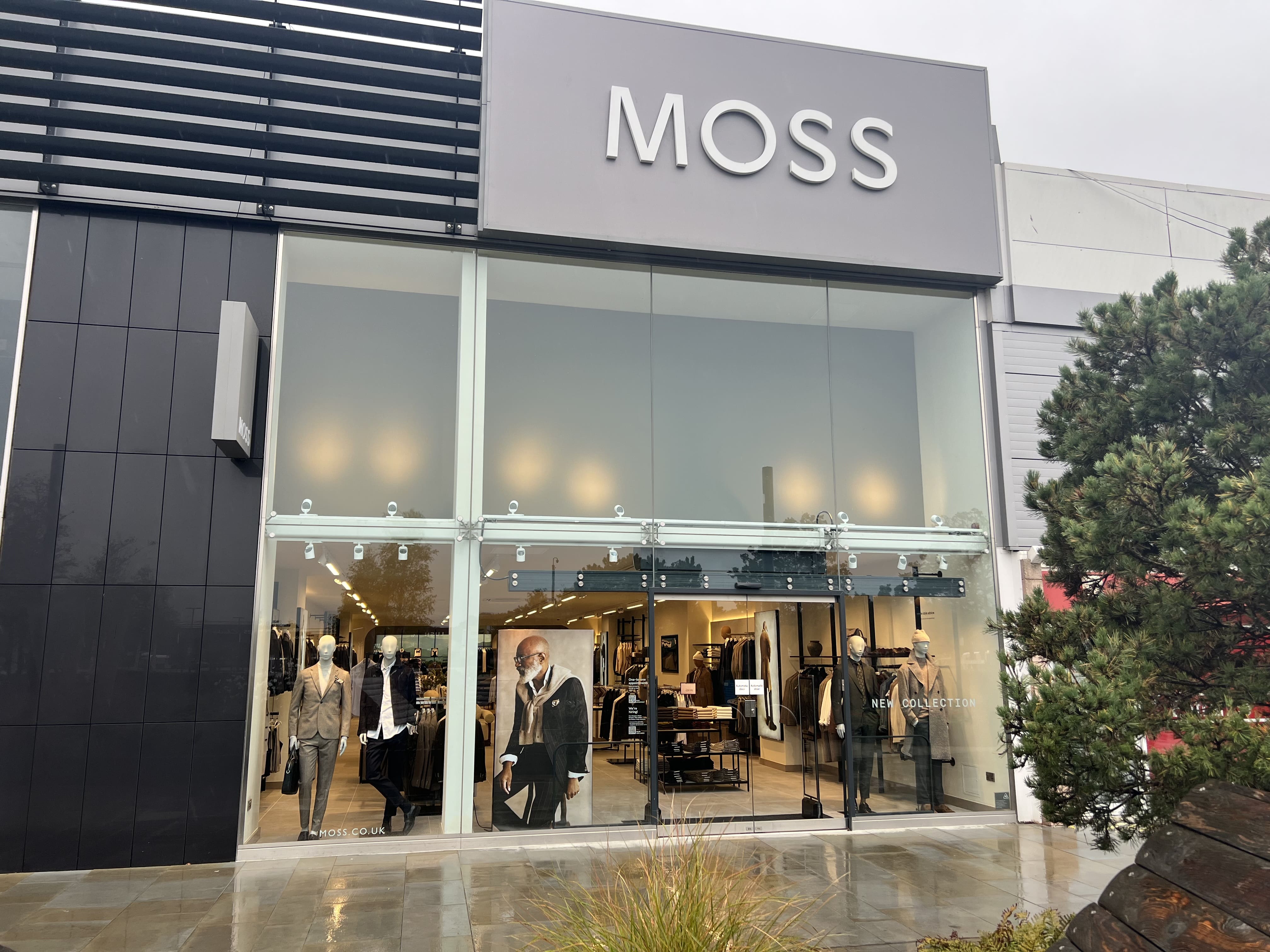 This image appears to be a photograph taken inside a men's clothing store, showcasing a selection of sophisticated, tailored garments and accessories.