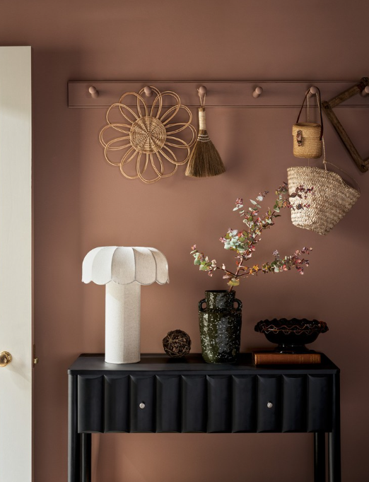 A variety of m&s homeware in place, including a white lamp and a vase of flowers.